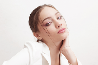Woman with a neutral expression on a white background